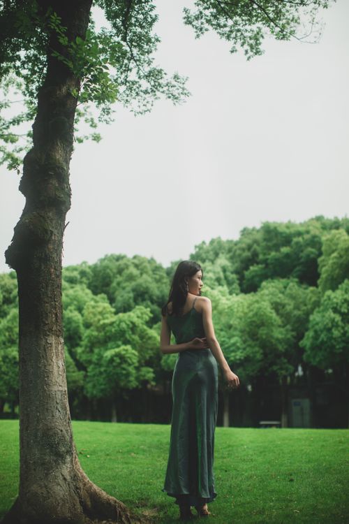 Female Model Wearing a Green Dress Standing in a Park Free Stock Photo Female Model Wearing a Green Dress Standing in a Park Free Stock Photo