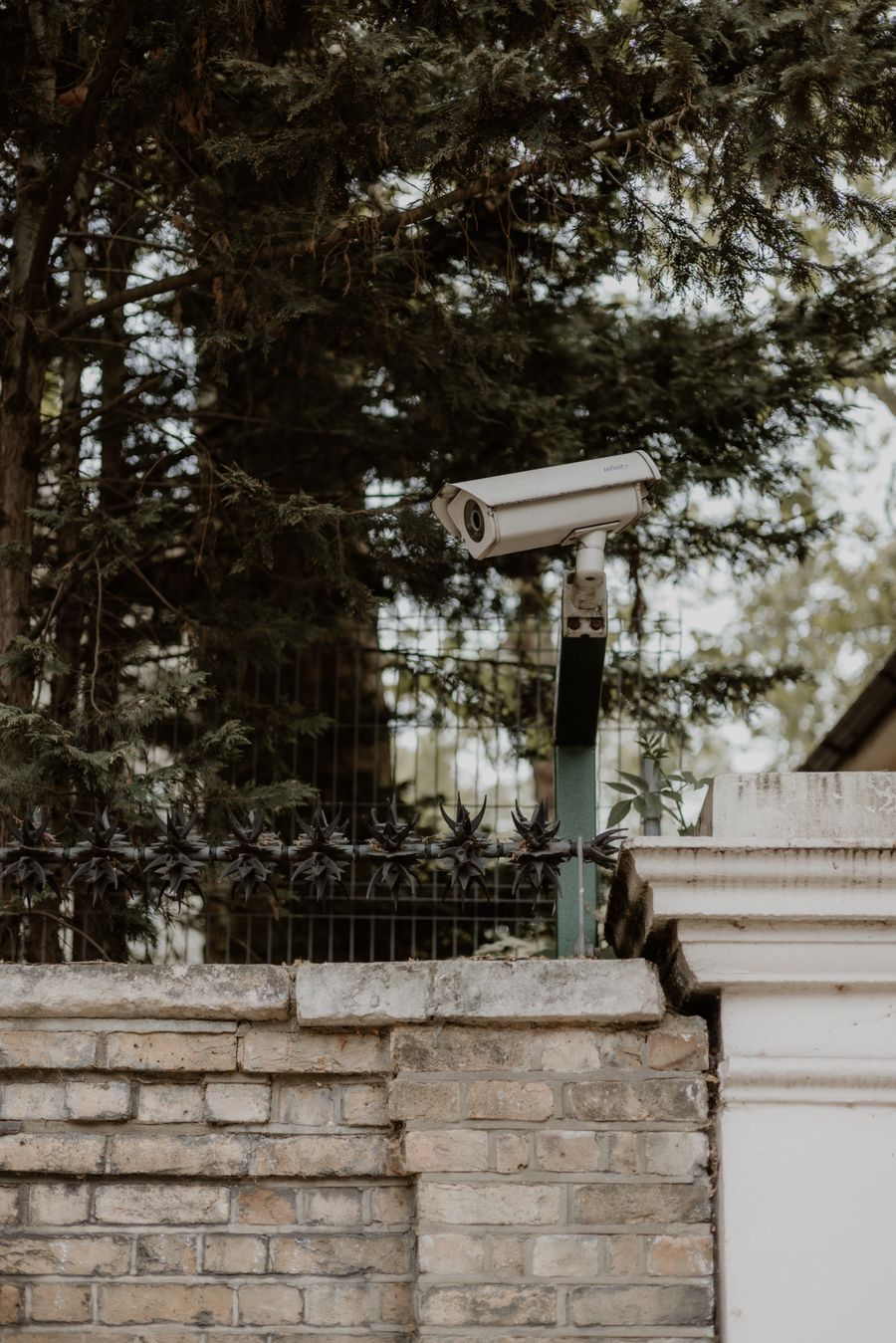 Real CCTV security camera mounted on an exterior brick wall in the UK