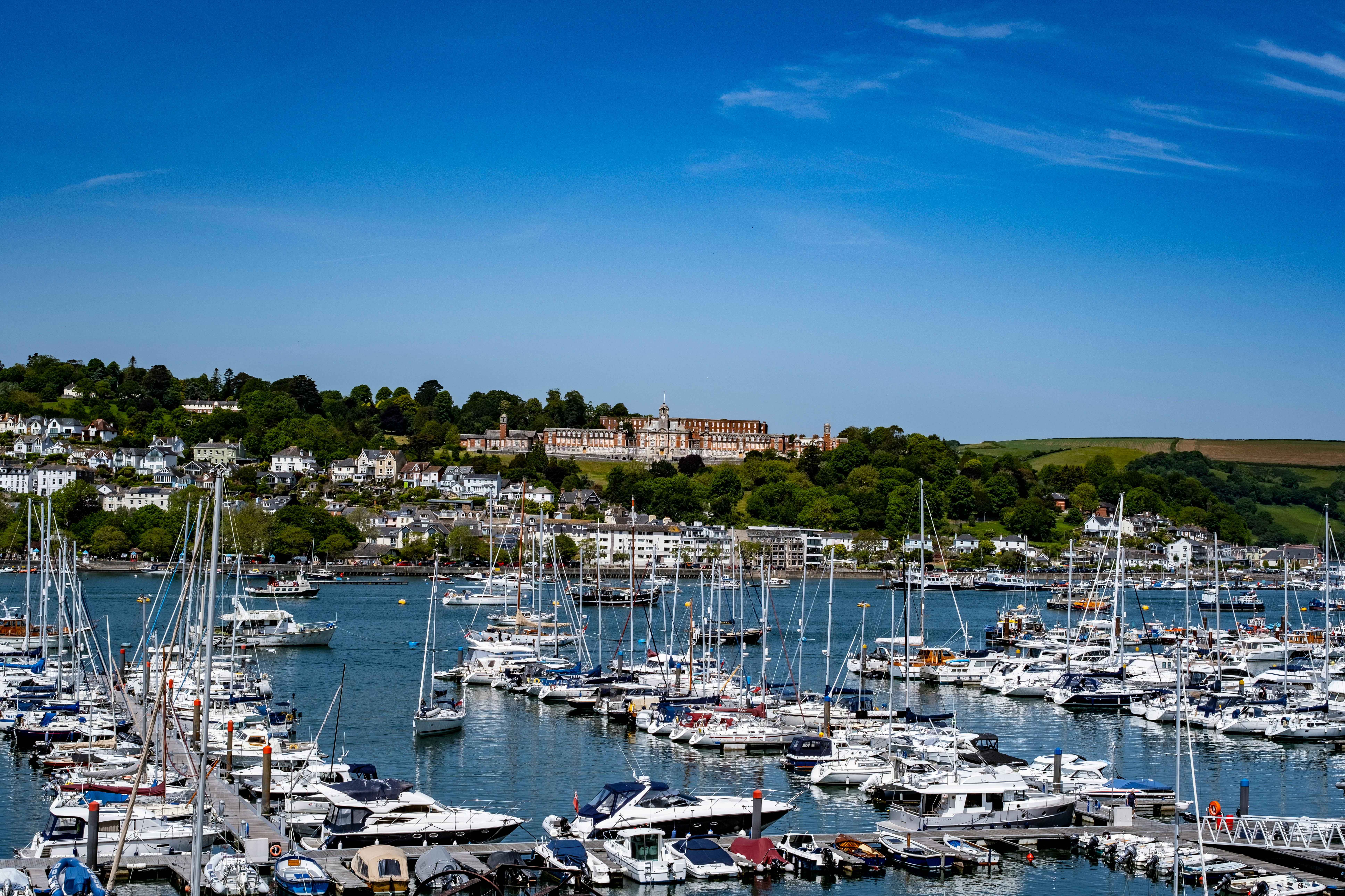 Discover the picturesque Dartmouth Marina in England with boats and stunning landscape.