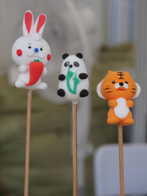 Free Close-up view of adorable candy sticks shaped like a panda, rabbit, and tiger. Perfect for sweet-themed designs. Stock Photo