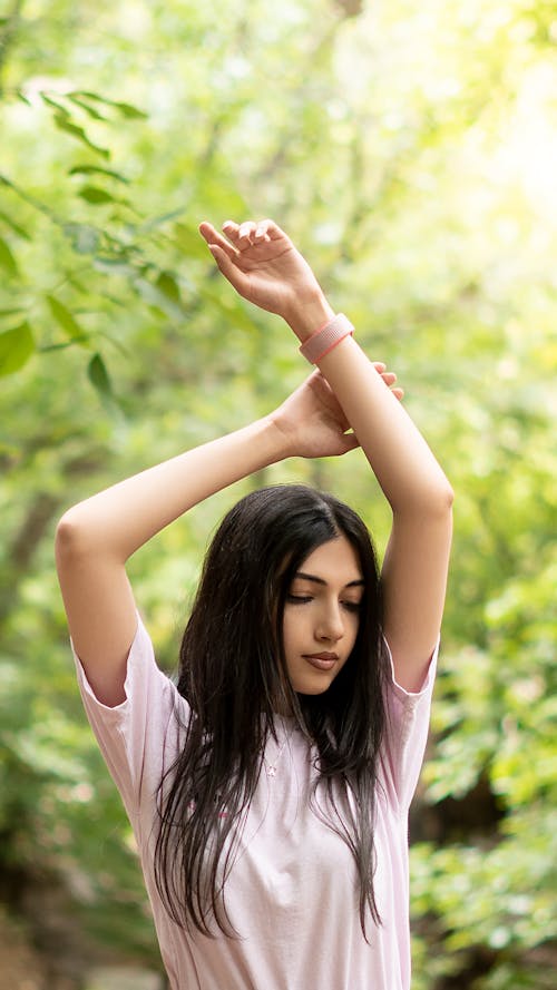 Brunette Woman with Arms Raised