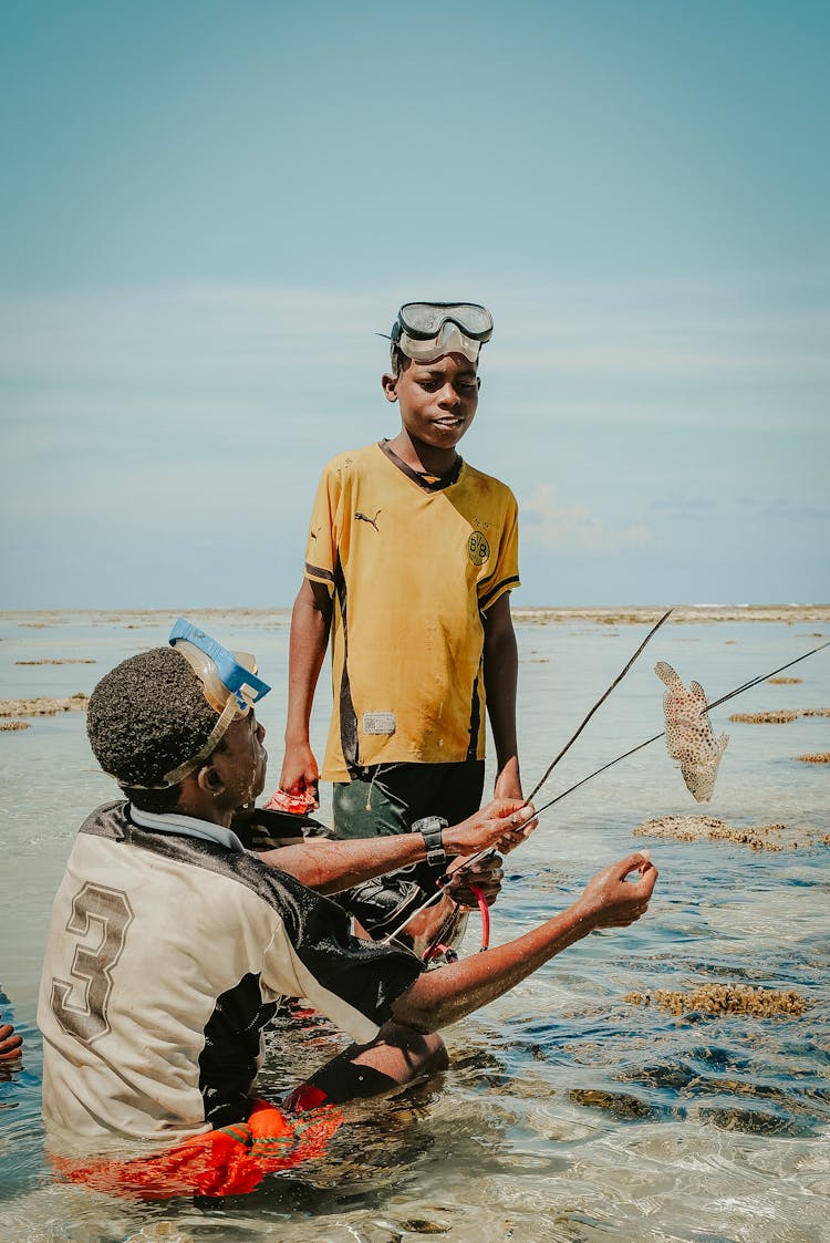 Father And Son Fishing On Shore