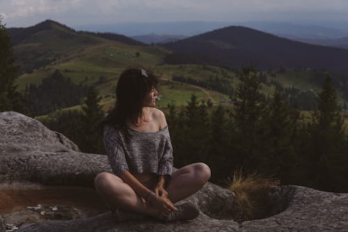 Woman Sitting on a Rocky Hill