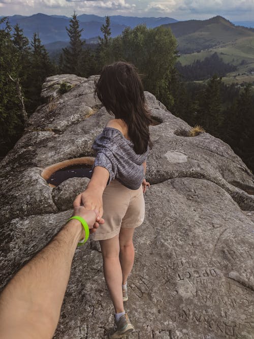 People Holding Hands on a Hill