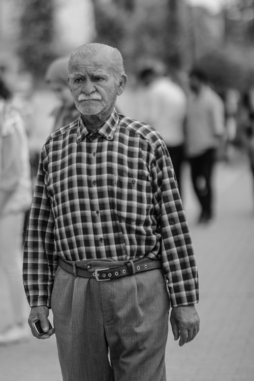 Free Black and white photo of an elderly man with mustache walking on a city street in Malatya, Türkiye. Stock Photo