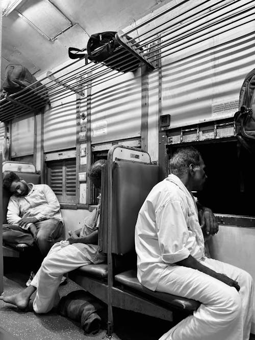 Free People Sitting in a Train in Black and White Stock Photo