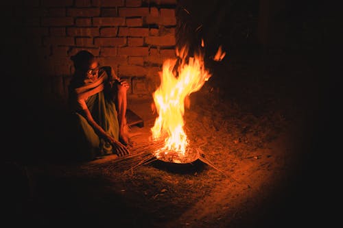 Free A Man Sitting by the Fireplace Stock Photo