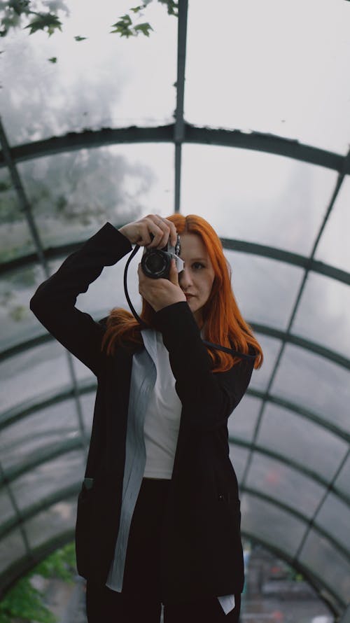 Redhead Woman Taking Pictures with Camera