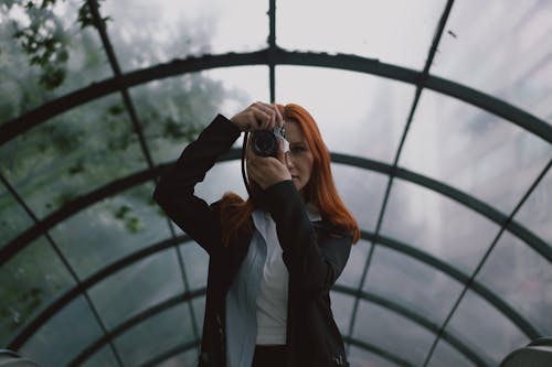 Redhead Woman Taking Pictures with Camera