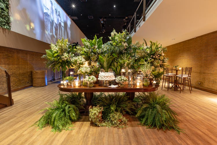 Cake Set On Table Surrounded By Plants