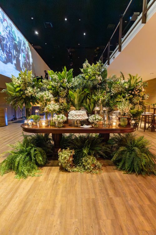 Free Lavish table centerpiece with lush greenery and flowers in a luxury venue setting. Stock Photo