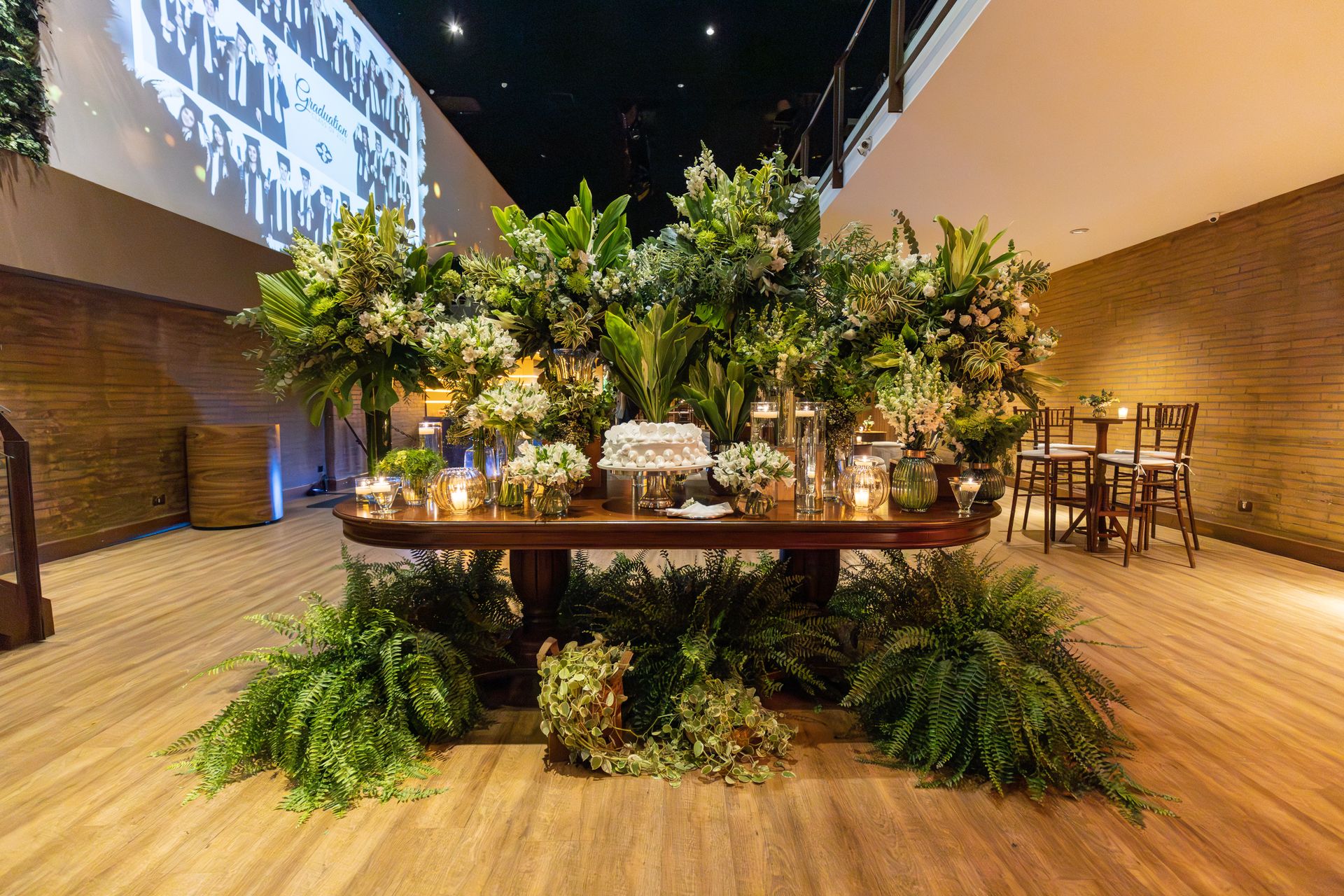 Elegant indoor banquet with lush floral arrangements and decorative candles. Perfect setting for special occasions.