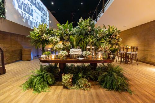Free Elegant indoor banquet with lush floral arrangements and decorative candles. Perfect setting for special occasions. Stock Photo