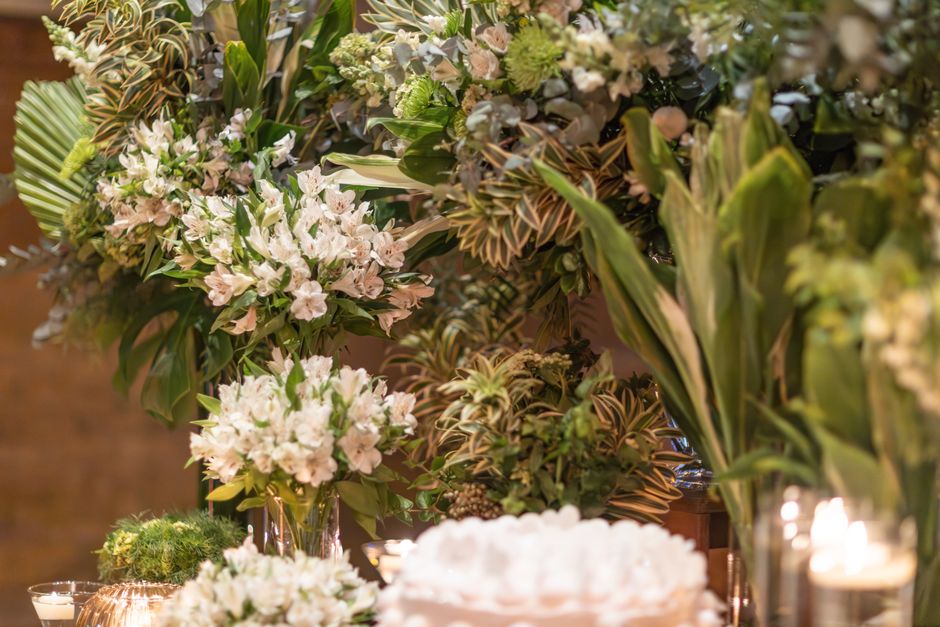 Stunning white and green floral arrangement for weddings or events, featuring lush greenery.