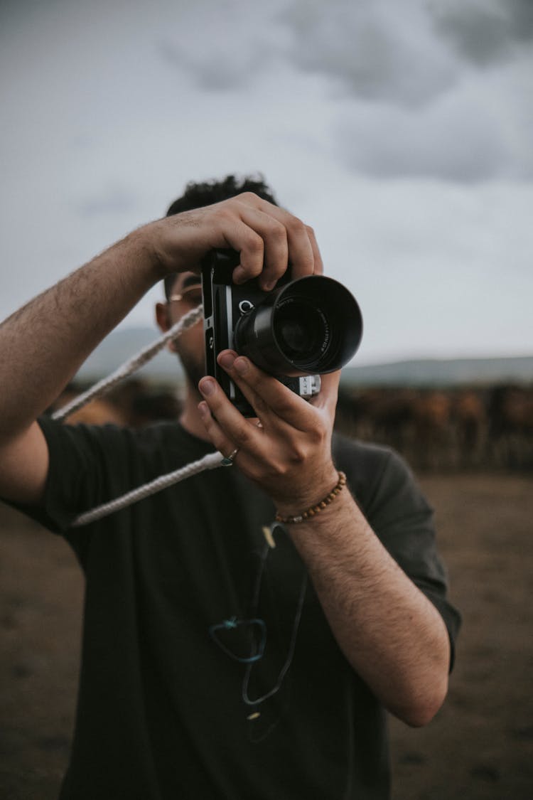 Man Taking Photo On A Field