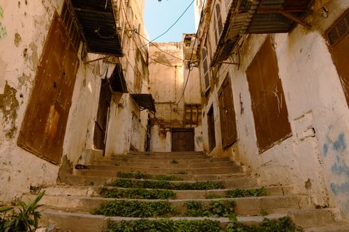 Free Explore the charming old-world allure of an abandoned alleyway in Algiers' Casbah, capturing historical architecture. Stock Photo