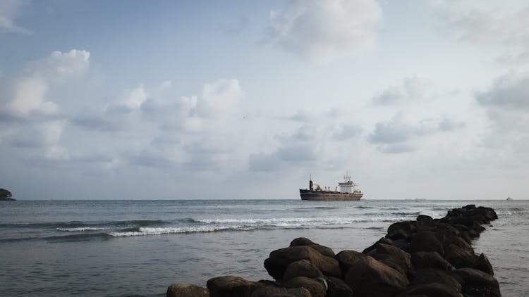 Waves And Ship On Sea Shore