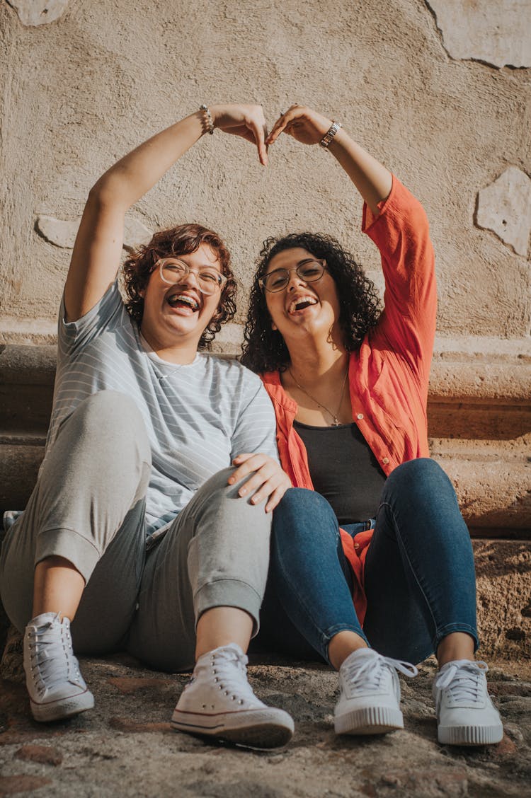 Women Making Heart Shape And Smiling