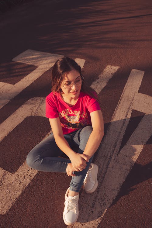 Young Woman Sitting on the Street 