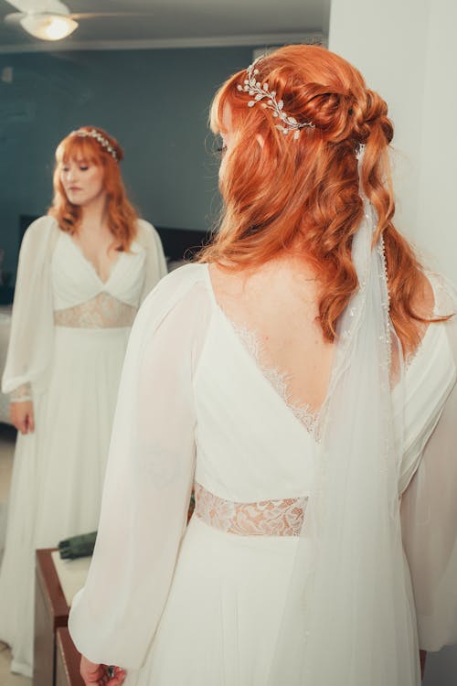 Bride in a Wedding Dress Standing in front of a Mirror 