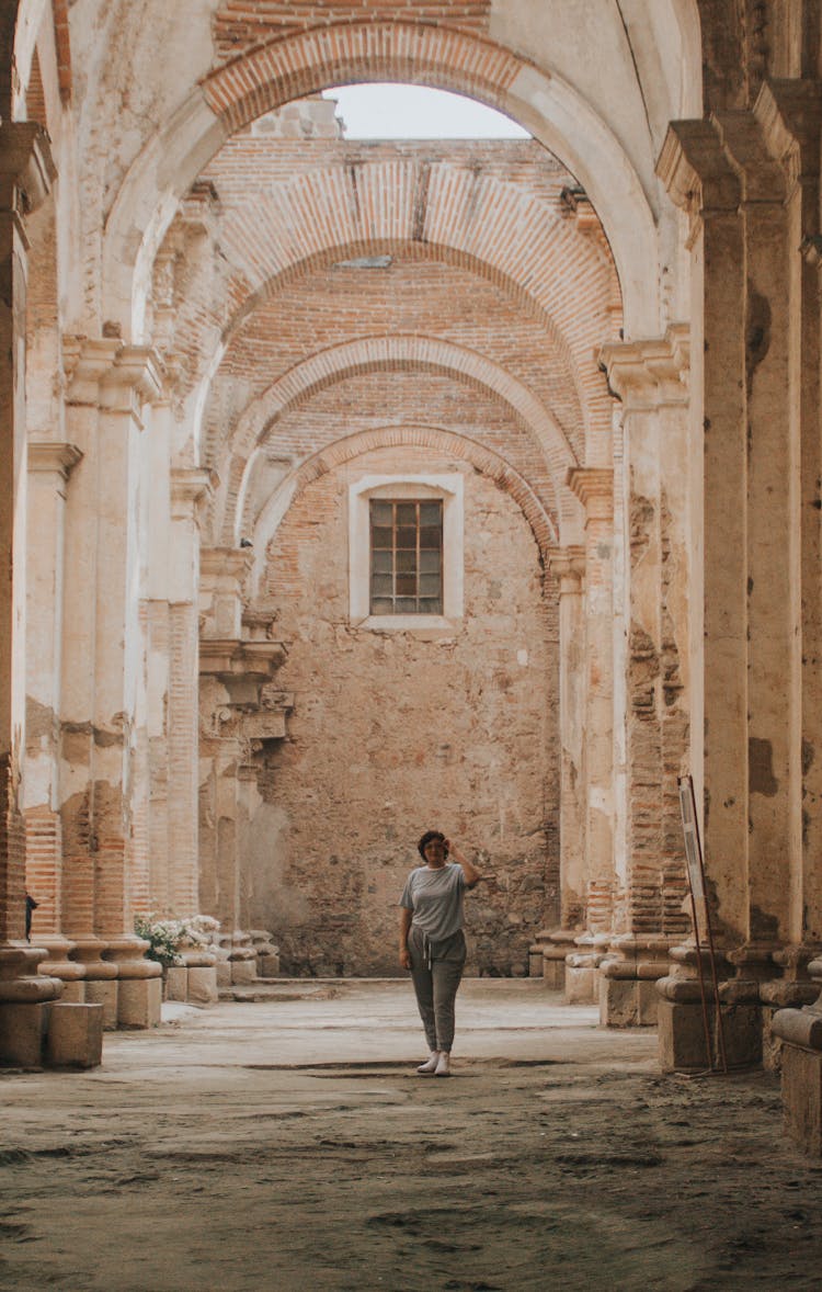 Woman In Building With Ornamented Arches