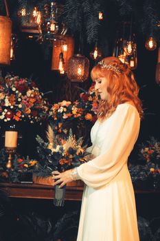 A stunning bride with a floral bouquet in a vintage, warmly-lit wedding setting.
