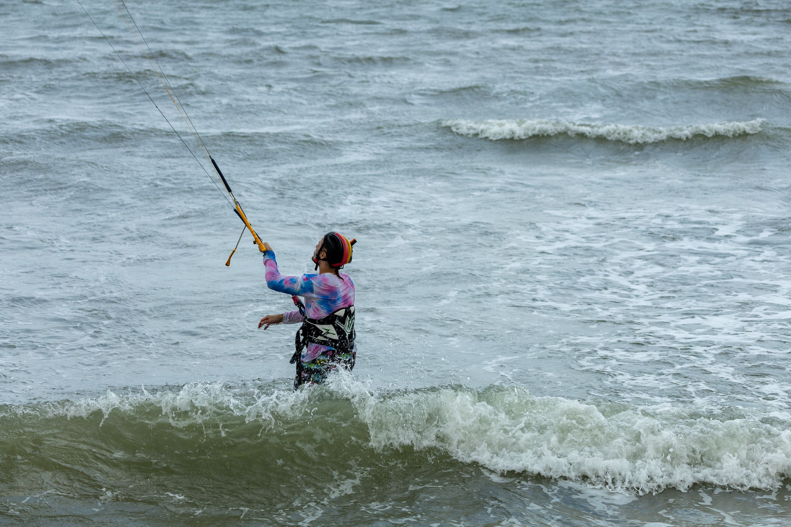 Man Standing in the Sea and Holding onto the Kite · Free Stock Photo