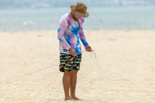 Man Untangling Power Kite Lines