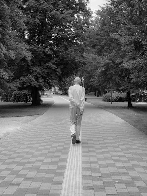 Elderly Man Walking at Park in Black and White