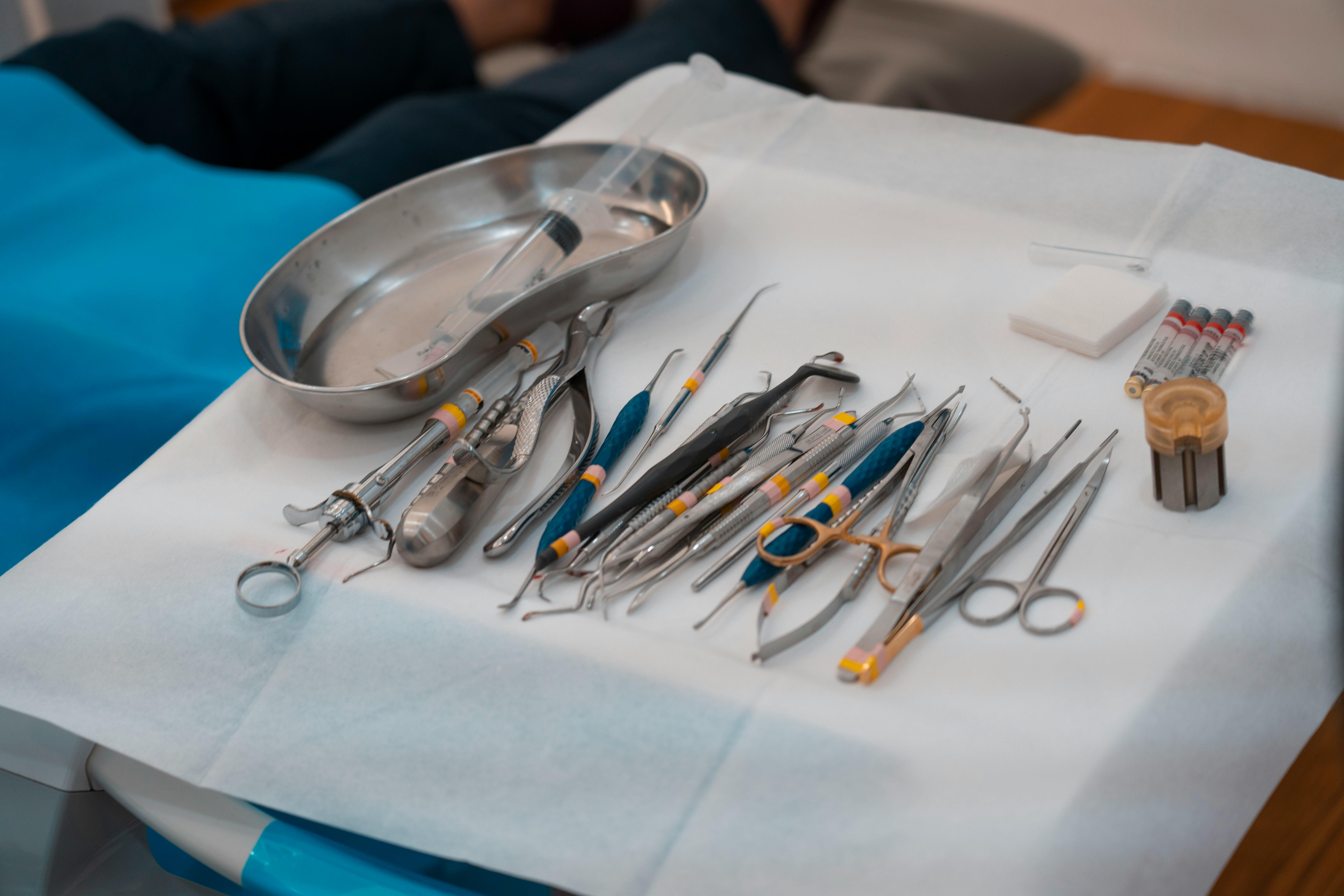 A neatly arranged set of dental tools on a sterile tray, showcasing essential medical instruments for dentistry.