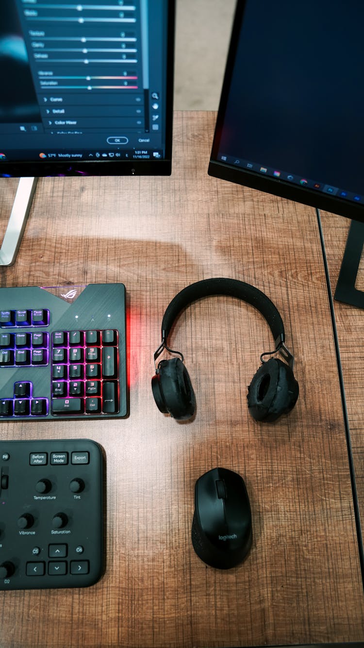 Monitors And Electronics On Desk