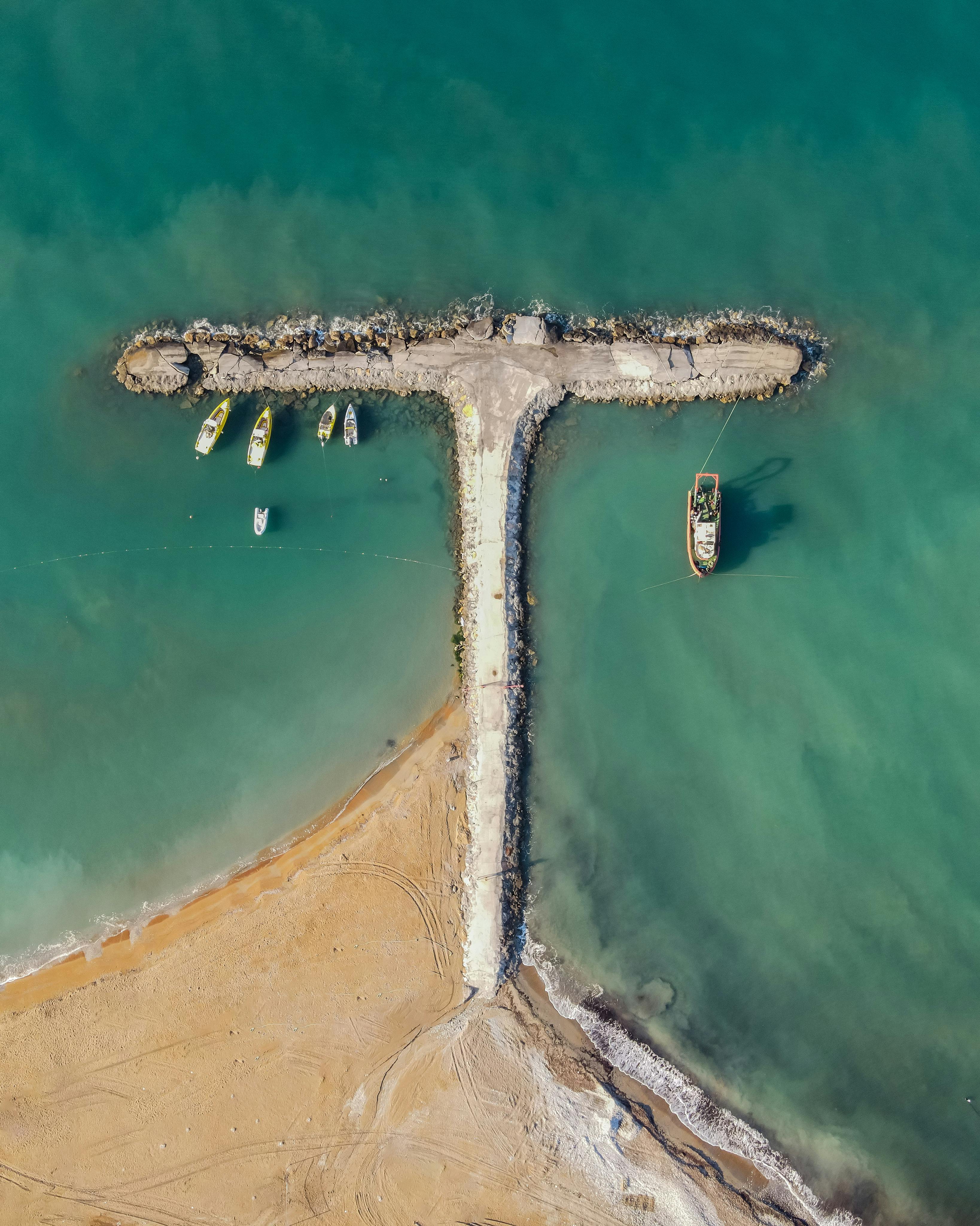 Drone shot of Alanya pier with boats on a sunny day in Türkiye.