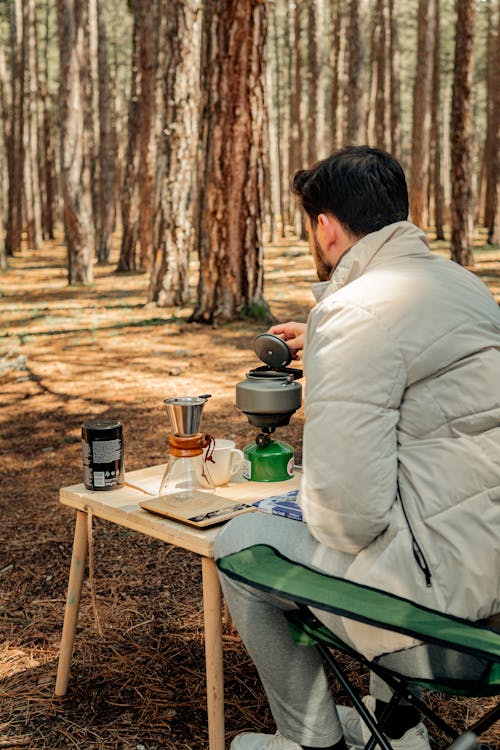 Man Sitting by Table in Forest