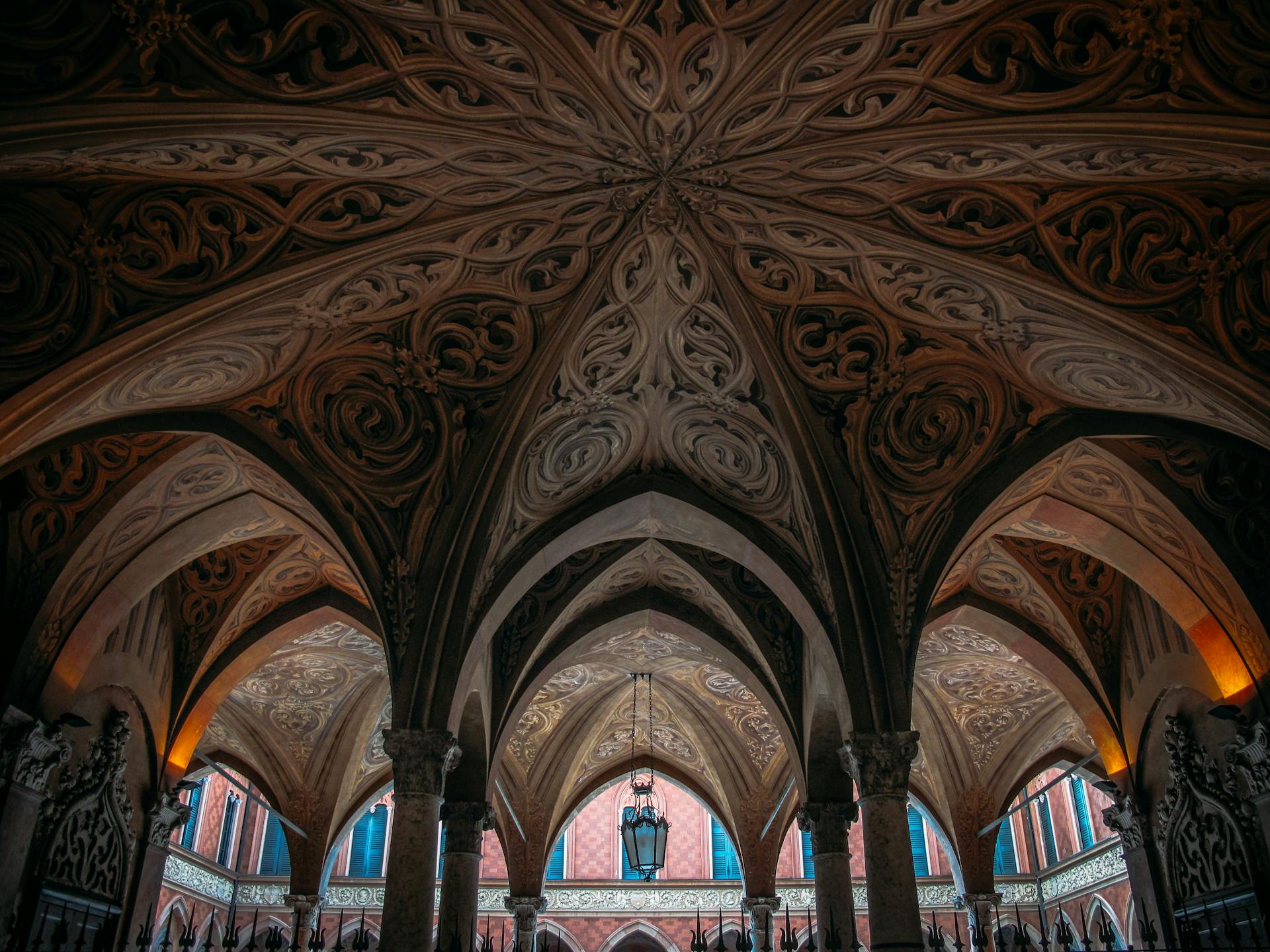 Explore the stunning intricate Gothic arches and ornate ceiling design in this captivating architectural photo.