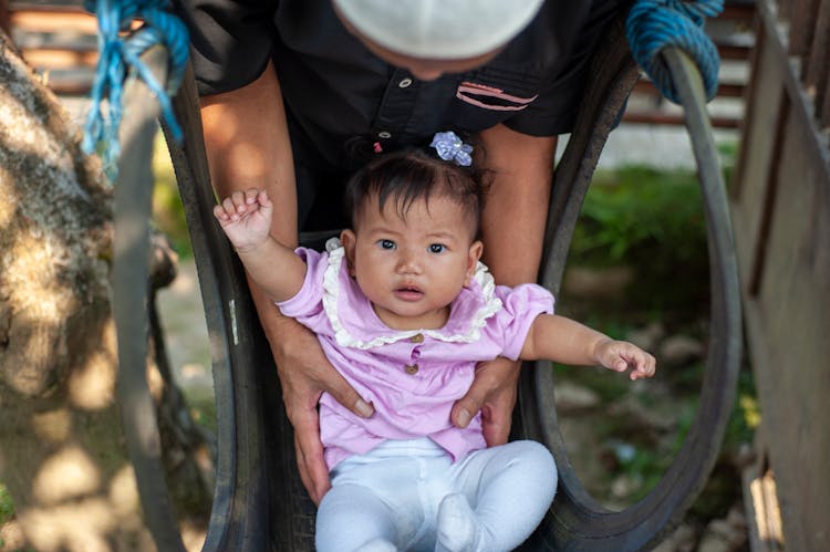 Man With Baby Girl In Playground