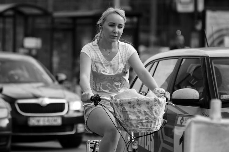 A Woman On A Bicycle In Black And White