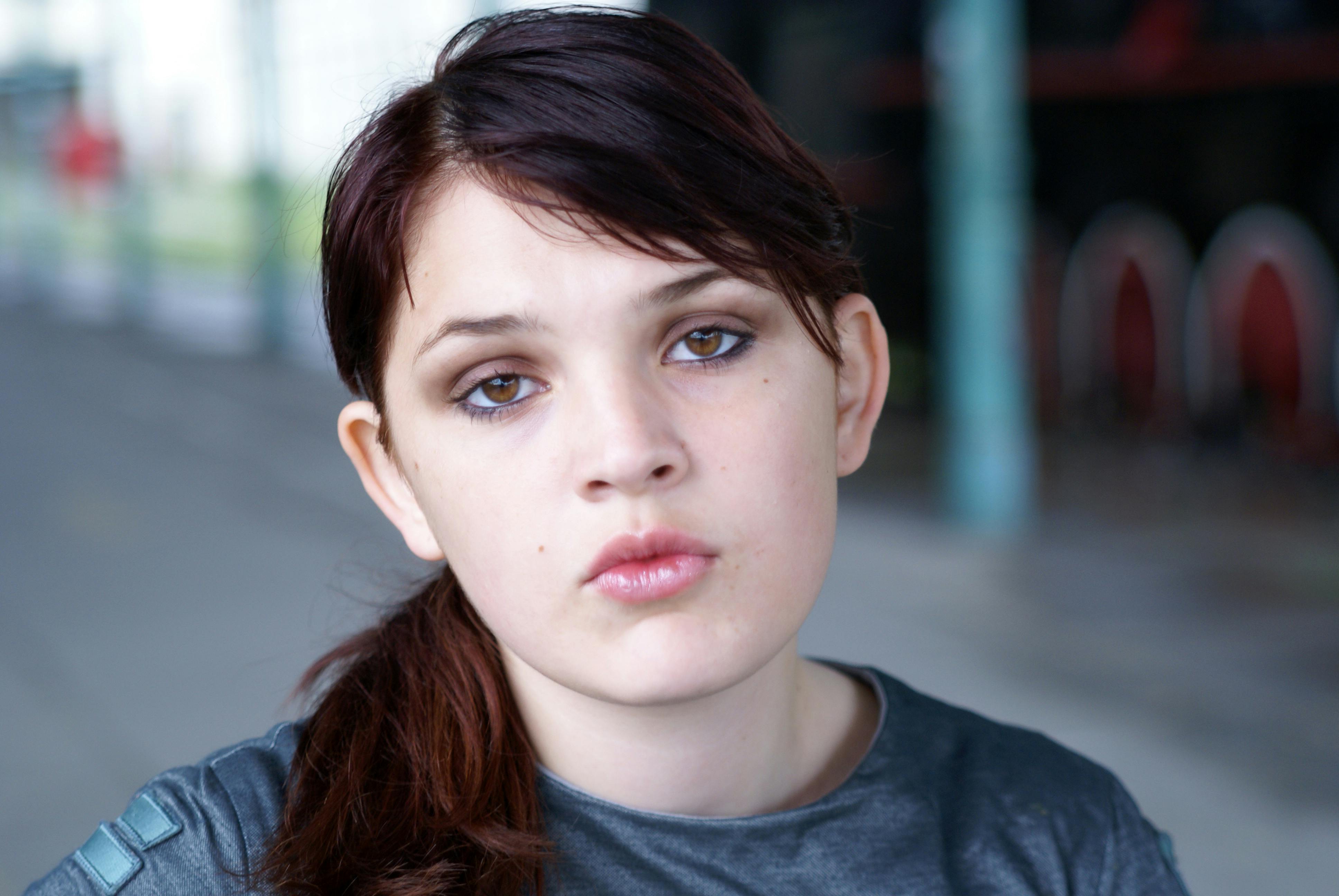 a young woman with brown hair and a black shirt