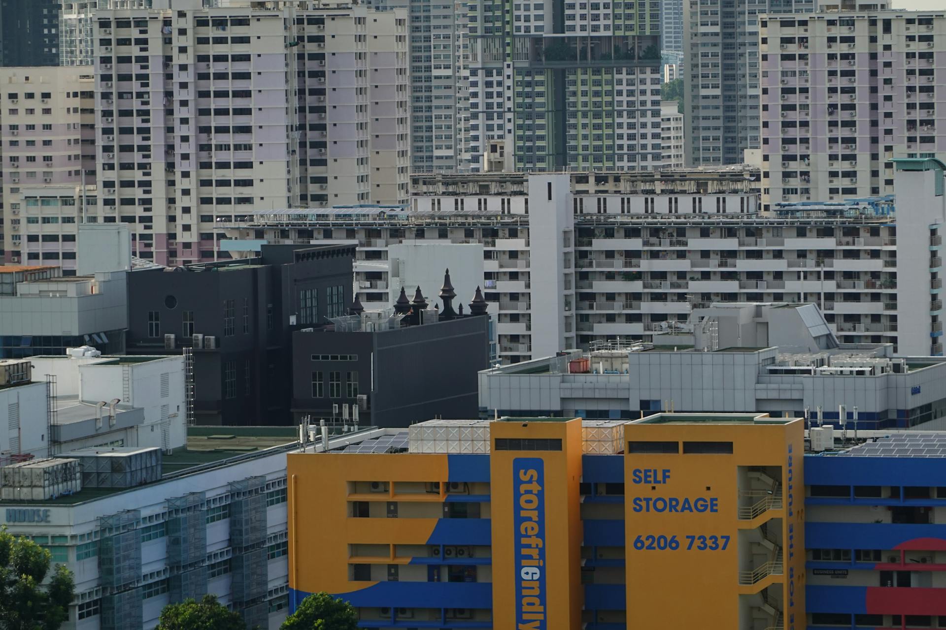 A view of dense residential buildings in Singapore showcasing urban living and self-storage facility.