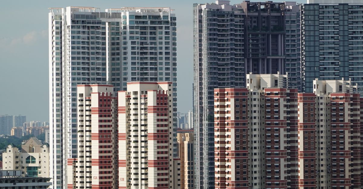 A cityscape featuring tall residential high-rise buildings under a clear sky.
