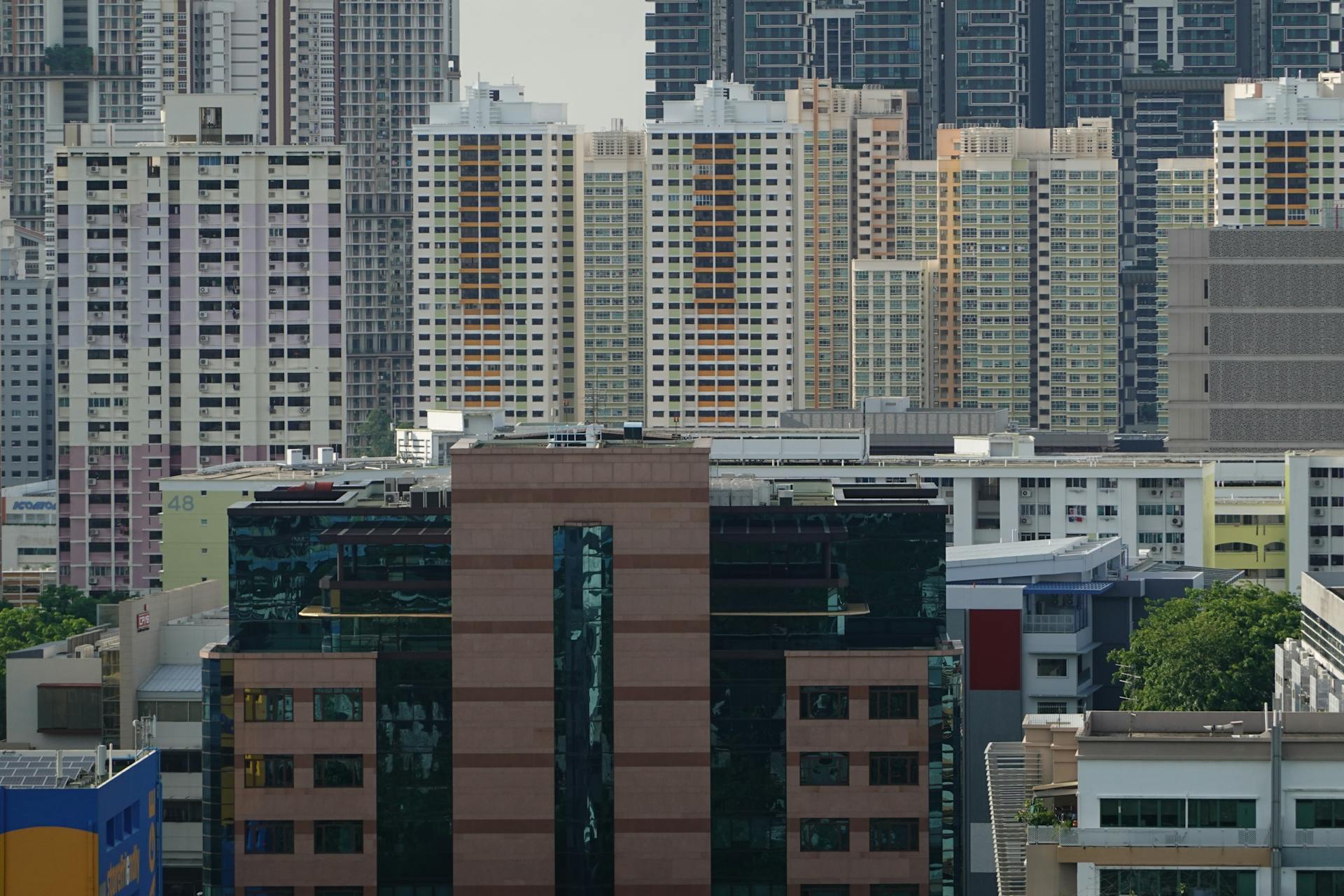 Aerial view of high-rise residential buildings in a dense urban setting, showcasing modern architecture.
