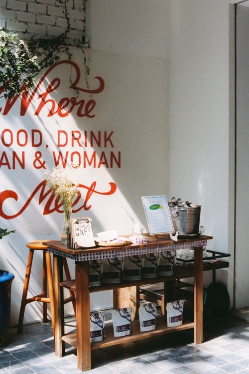 Free A charming wooden table setup in a café featuring rustic decor and a welcoming atmosphere. Stock Photo