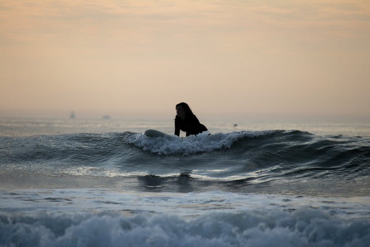 Surfing At Sunrise In Deal Beach, NJ