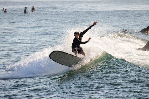 Man Surfing on Sea Shore