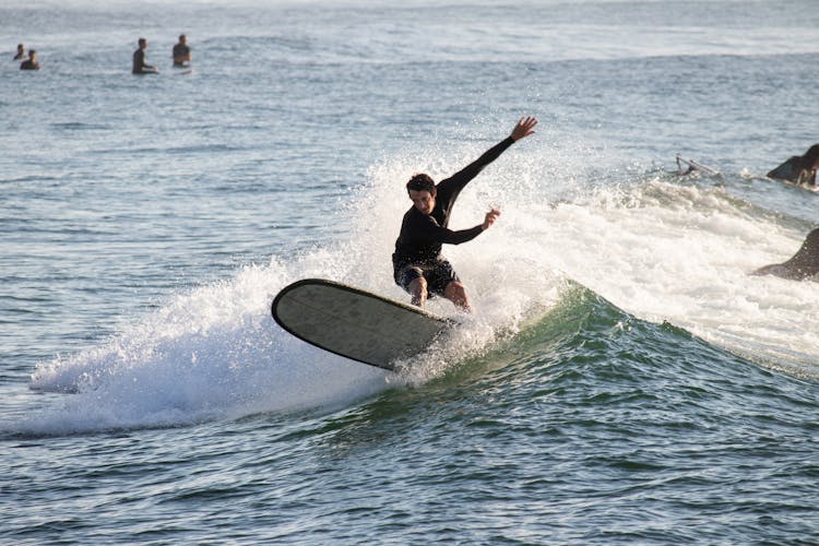 Surfing At Sunrise In Deal Beach, NJ