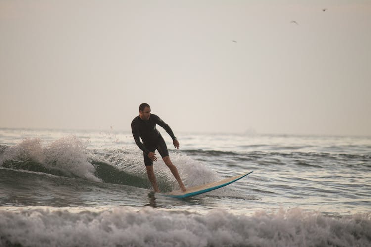 Surfing At Sunrise In Deal Beach, NJ