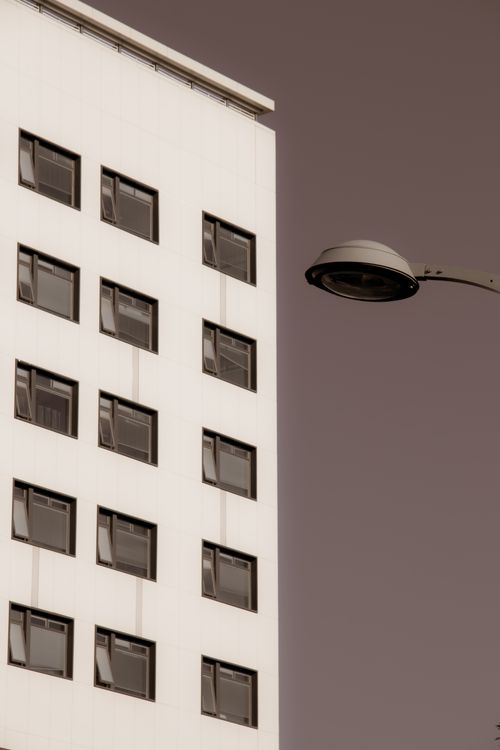 Free Minimalist urban architecture with a focus on a building's exterior and streetlight. Stock Photo