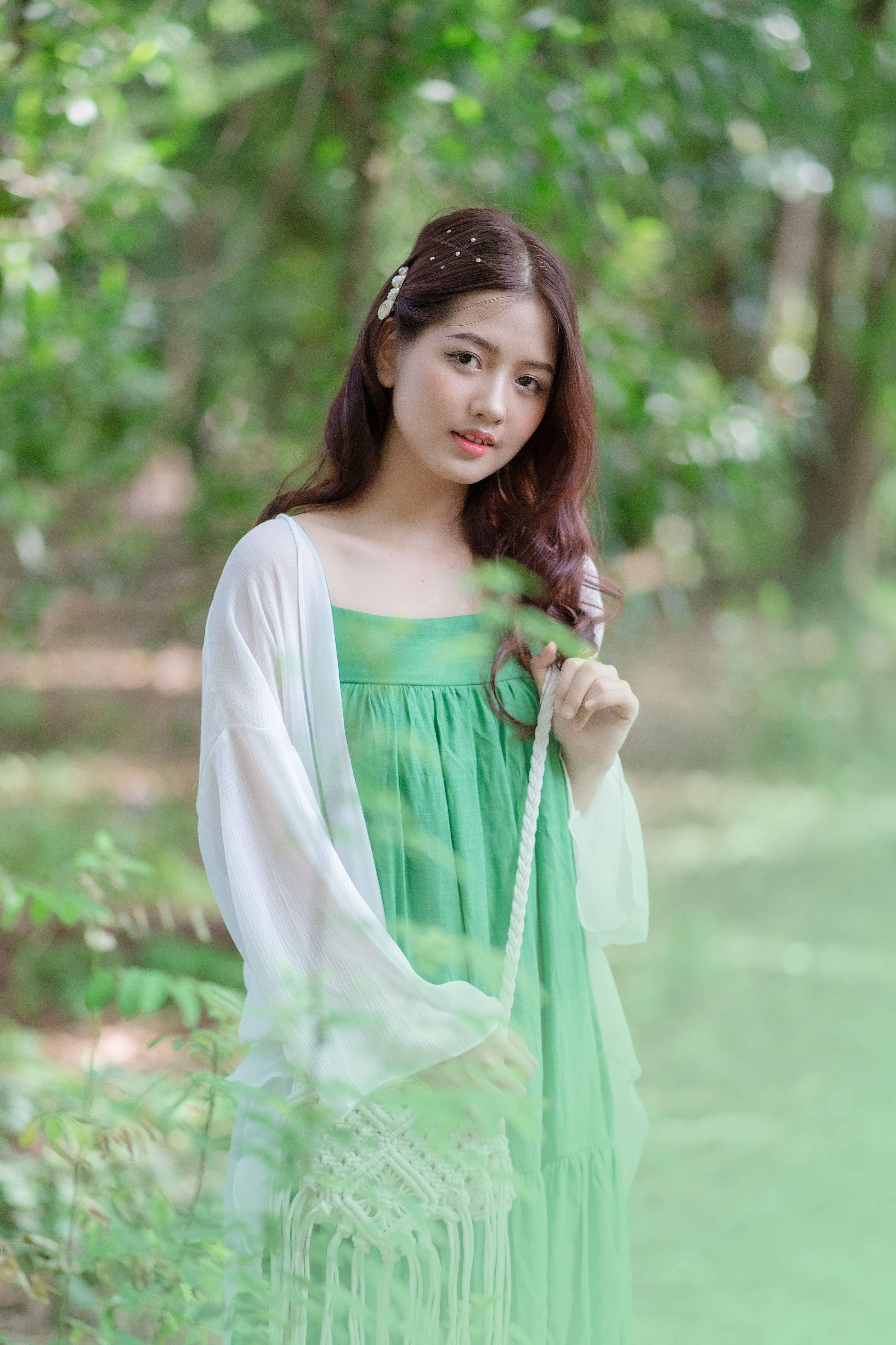 Young Woman in a Green Dress Posing Outdoors · Free Stock Photo
