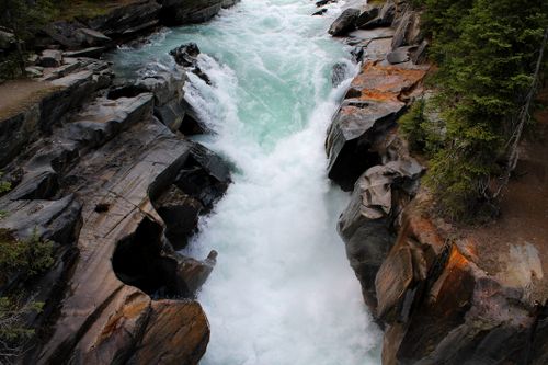 Free Breathtaking view of a waterfall in Radium Hot Springs, showcasing rugged rock formations. Stock Photo