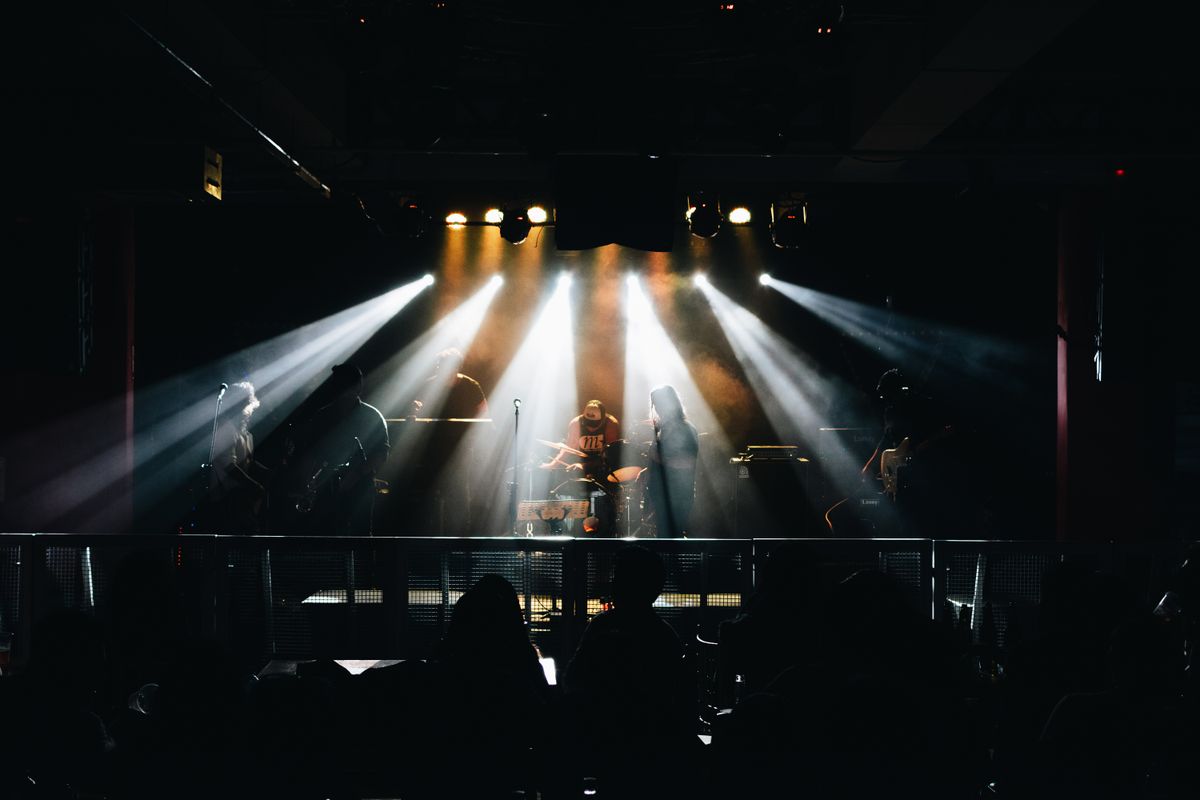 The band mid-song under dramatic lighting