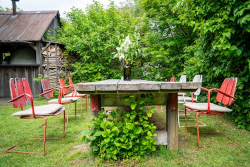 Wooden Table with Chairs in Yard